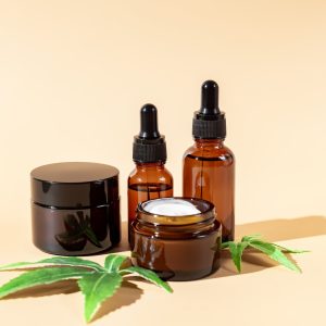 Cannabis face cream, serum or oil dropper concept. Natural cosmetic. CBD oil, THC tincture and hemp